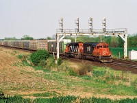 During a spring evening, a short CN 271 with SD40u 6004 and SD40 5052 are viewed heading westbound under the Paris West signal bridge on the Dundas Subdivision. 