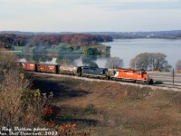 CP Rail SD40 5528 and leased Chesapeake & Ohio GP35 3570 smoke it up heading up an eastbound extra freight on the CP Hamilton Sub, on the approach to Hamilton Junction (with the CP Goderich Sub and CN Hamilton Sub). Highway 403 and the fall colours around Cootes Paradise are visible in the background.<br><br>This spot would later be upgraded as the <a href=http://www.railpictures.ca/?attachment_id=11148><b>Desjardins</b></a> interlocking plant by CP.<br><br><i>Reg Button photo, Dan Dell'Unto collection slide.</i>