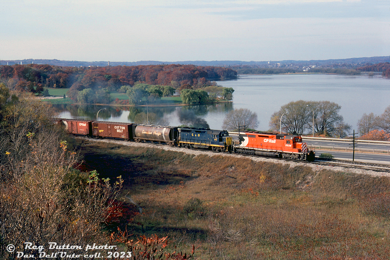 CP Rail SD40 5528 and leased Chesapeake & Ohio GP35 3570 smoke it up heading up an eastbound extra freight on the CP Hamilton Sub, on the approach to Hamilton Junction (with the CP Goderich Sub and CN Hamilton Sub). Highway 403 and the fall colours around Cootes Paradise is visible in the background.

This spot would later be upgraded as the Desjardins interlocking plant by CP.

Reg Button photo, Dan Dell'Unto collection slide.