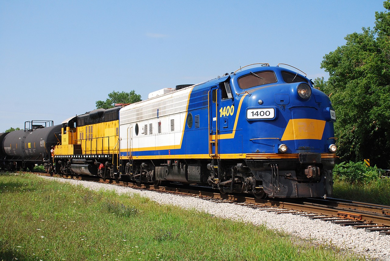 Steve's recent post of OSRX 1400 and Matthew Whiteley's subsequent comment that the unit last ran in the Summer of 2020 led me to look through my uploaded photos to see my shot of it. I came up empty. I don't know how you guys with over a thousand photos on here keep track of all of them. Anyway, here's the shot I was looking for, of Ontario Southland 1400 and 102 returning from Tillsonburg. They would do some work in Ingersoll before heading to St. Thomas with one tank car. I too encourage you to support the Via Historical Association (VHA) in their purchase and restoration of OSRX 1400 to VIA 6539 so I can relive my youth and see a blue/yellow VIA F-unit in action again! Can we also start a fund to acquire a MLW FPA-4 from someone?  :)