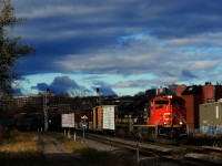 Heritage unit NS 1065 is trailing as CN 324 heads east with a high headlight SD70M-2 leading.