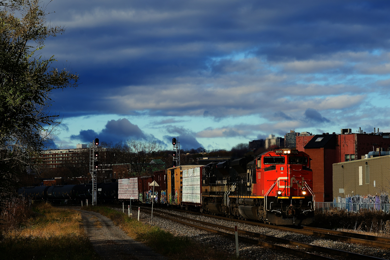 Heritage unit NS 1065 is trailing as CN 324 heads east with a high headlight SD70M-2 leading.