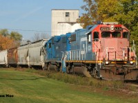 CN L540 with GTW 6224 and CN 4910 are shoving across Queen Street on the Huron Park Spur in Kitchener, Ontario as they return from lifting cars at the CP interchange. 
<br>
One year later and as of this October crews were in the process of removing the former Kissner Milling silos seen in the background. 
