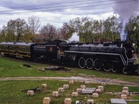<a href=https://www.railpictures.ca/?attachment_id=50782>After arriving at Cobourg and cutting off from its train,</a> CNR 6167 shoves the baggage car of fans around the wye in preparation to return west to Oshawa, and Toronto Union Station.  Today's excursion included a stop at Oshawa for traction fans to take in the Oshawa Railway operations which were in the last few years of service. This day marked the last train down King Street, celebrated by a parade as motor 300 hauled a single boxcar through town.<br><br>Once around the curve, 6167 will be on the remnants of the Cobourg & Peterborough Railway, built in 1853.  The line later came under control of a few small companies and ultimately the Grand Trunk Railway before abandonment circa 1898.  A small portion is still in use to serve the Canada Pallet Corporation about a quarter mile away from this scene.  Additionally, in the grass area beyond the baggage car, just above the conductor, the former CNR Orono Subdivision, originally the Canadian Northern Railway Toronto - Ottawa mainline, crossed this scene until abandonment in 1923/1924.  The spur leading in that direction used a very short stretch of the old main to access a few industries east here that have since stopped using rail.<br><br>Steve Bradley would shoot the special after its westbound departure from Oshawa <a href=https://www.railpictures.ca/?attachment_id=34409>highballing through Port Union.</a><br><br><i>Tom J. Gascoigne Photo, Jacob Patterson Collection Slide.</i>