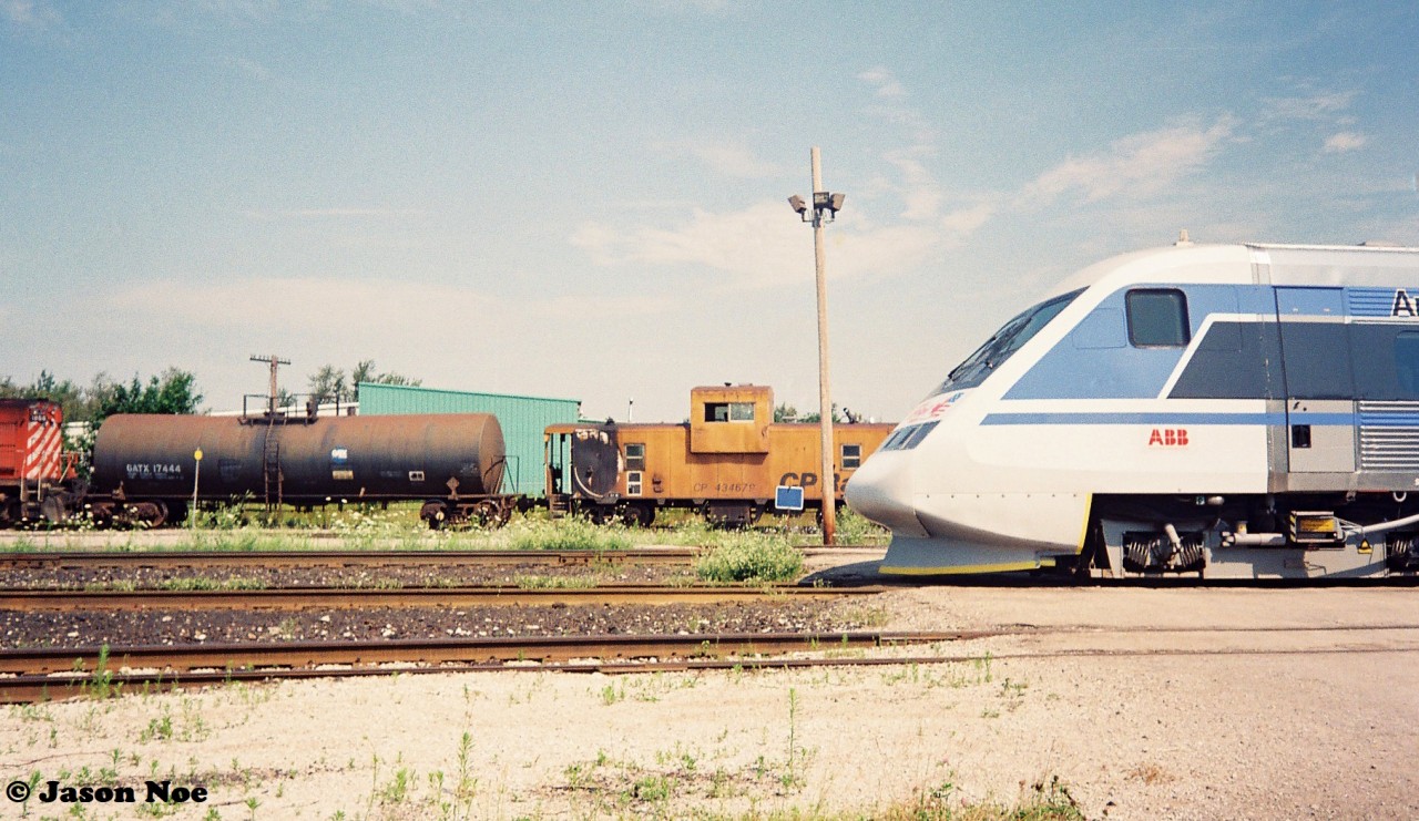 In summer 1993, my first trip to CP Guelph Jct. ironically wasn’t to photograph a CP train, but rather a promotional passenger train set. So the story goes, in July of that year CP sponsored the tour of the X2000, which was a Swedish State Railways train set built by Asea Brown Boveri (ABB) on their lines in Quebec and Ontario. The week-long promotional tour of the two provinces then followed several months of testing and display of the train in the United States by Amtrak. The Toronto portion of the tour was followed by two X2000 excursions to Guelph Junction and return via the Galt Subdivision. I forget exactly how we found out about it, which was likely through word of mouth at the time, but my dad, myself and a friend arrived at Guelph Jct. ahead of the train’s arrival and immediately realized we weren’t the only ones there. Many other railfan’s, the media and everyone else in between were there to take in the event.

Here the X2000 train is viewed with the CP local to Guelph in the background powered by RS18u 1866 with caboose 434679 on the tail-end.