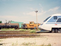 In summer 1993, my first trip to CP Guelph Jct. ironically wasn’t to photograph a CP train, but rather a promotional passenger train set. So the story goes, in July of that year CP sponsored the tour of the X2000, which was a Swedish State Railways train set built by Asea Brown Boveri (ABB) on their lines in Quebec and Ontario. The week-long promotional tour of the two provinces then followed several months of testing and display of the train in the United States by Amtrak. The Toronto portion of the tour was followed by two X2000 excursions to Guelph Junction and return via the Galt Subdivision. I forget exactly how we found out about it, which was likely through word of mouth at the time, but my dad, myself and a friend arrived at Guelph Jct. ahead of the train’s arrival and immediately realized we weren’t the only ones there. Many other railfan’s, the media and everyone else in between were there to take in the event.
<br>
Here the X2000 train is viewed with the CP local to Guelph in the background powered by RS18u 1866 with caboose 434679 on the tail-end.  
