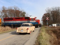  The driver of the 1953 Ford Customline waits patiently as RLK 4095 (SOR 591) occupies the crossing on Concession 4, Walpole, southbound to Nanticoke. The X Rail Signal Maintainer is busy on site doing scheduled tests and inspections.


