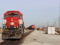 While the crew on SOR 591 (RLK 4095 QGRY 2301) builds their train on the lead, the crew on CN L502 (CN 3225 CN 3940) load their bags into the cab, then will head to the north end of the yard, restore the derail and will be off to take their rest. 