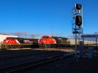 G 81141 25 rolls through West Junction with CN 3015 leading.  Parked at the diesel shop, is the power for the CN Christmas Express, which consists of CN 2107 and CN 2112, both sporting the 15 year IPO anniversary scheme. 