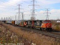 In a world of GE's and boxy SD70-variants, it's always nice to see the lines of classic 90's EMD widecabs leading: CN SD75I's 5694 and 5633 roll a long slow 422 through the plant at Snider West, on the last leg of their trip to MacMillan Yard. A dimensional load (a pair of industrial steam generators?) rides a heavy duty flatcar up front.