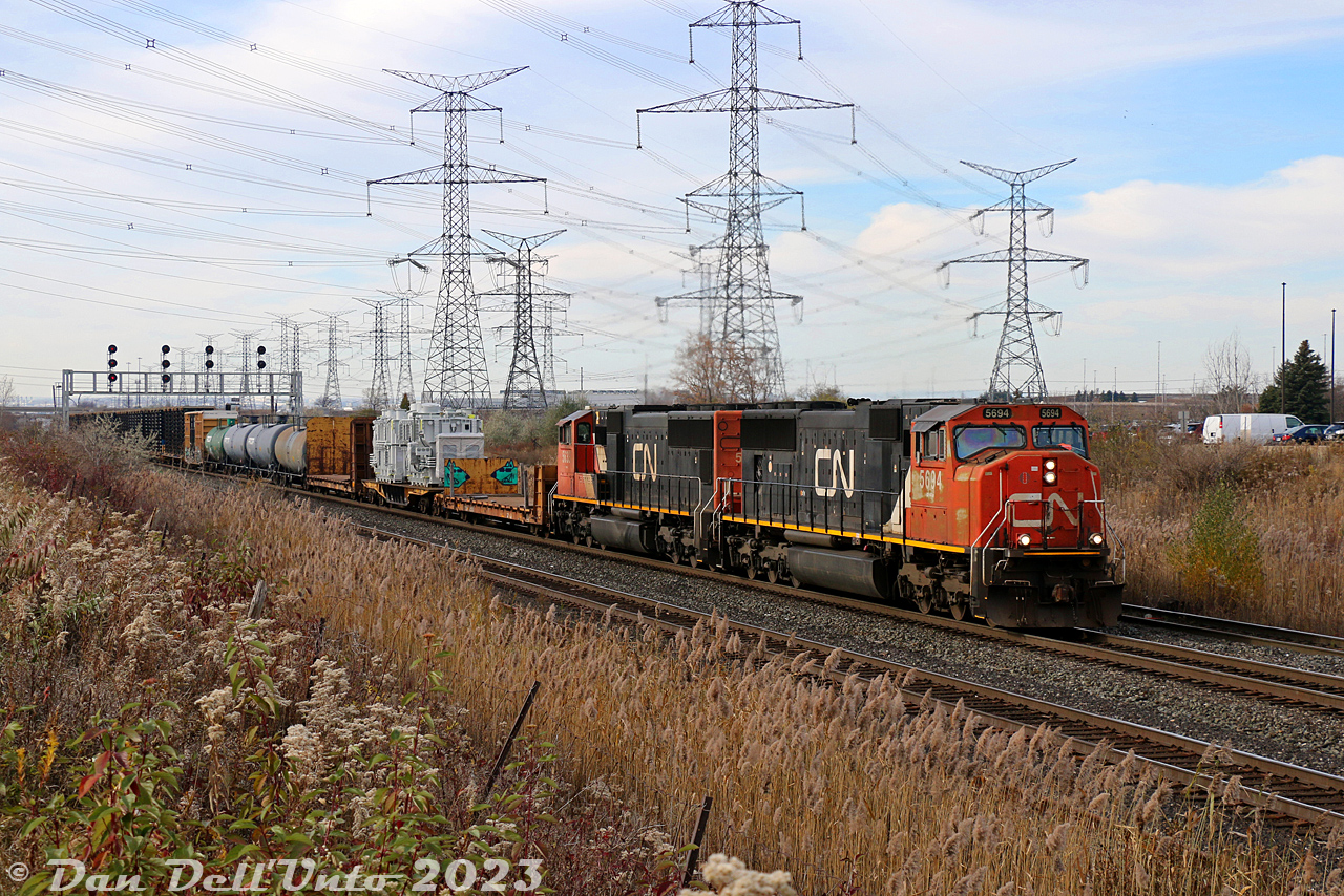 In a world of GE's and boxy SD70-variants, it's always nice to see the lines of classic 90's EMD widecabs leading: CN SD75I's 5694 and 5633 roll a long slow 384 through the plant at Snider West, on the last leg of their trip to MacMillan Yard. A dimensional load (a pair of industrial steam generators?) rides a heavy duty flatcar up front.