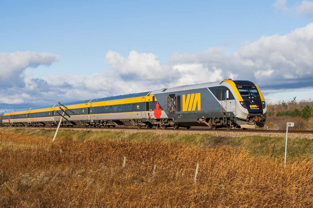 Well it took a while for me to finally connect with these in a photogenic way. Here is VIA #24 blasting out of Ottawa on Saturday October 28, having no trouble achieving track speed. This train made it to its first stop in Alexandria 7 minutes ahead of schedule.
Connecting with this train was made possible by VIA's announcement the week before on social media of a scheduled rotation for several "New Fleet" sets. This was assisted by the departure of #24 coinciding with (what felt like) Ottawa's only hour of sunlight that weekend.
In addition to replacing the legacy fleet, these sets may also spell the end of grabbing passenger train consists on the fly, for those so interested. I usually try to record them when I can - but the numbers on these cars are smaller that the fine print on a cell phone contract, so at 100 mph there is no chance. The cab car was 2303 for those who care.