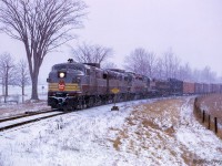 CP 902 departs Agincourt Yard for Montreal via the Staines Lead, approaching the junction with the Oshawa Subdivision.  Note GMD GP30 8200 third up.  Delivered in March 1963, it and sister 8201 were <a href=https://www.railpictures.ca/?attachment_id=41079>renumbered to CPR 5000 and 5001</a> in 1965.  Both survive today, with the 5000 at the Alberta Railway Museum, and the as a grain elevator switcher in Fremont, Nebraska.<br><br><i>Scan and editing by Jacob Patterson.</i>