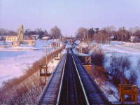 After meeting <a href=https://www.railpictures.ca/?attachment_id=53077>VIA train 660 at the east end of Credit, </a> VIA 661 is once again on the move westbound crossing the Credit River just east of Georgetown.  In the distance, an eastbound freight for Mac Yard, led by CN 3129, waits for us to clear.  Note the 'Credit' name sign just beyond the bridge at right.<br><br>Engineer Phil Hall captured a similar scene <a href=https://www.railpictures.ca/?attachment_id=24811>seen here in 2016.</a><br><br><i>John Freyseng Photo, Jacob Patterson Collection Slide.</i>