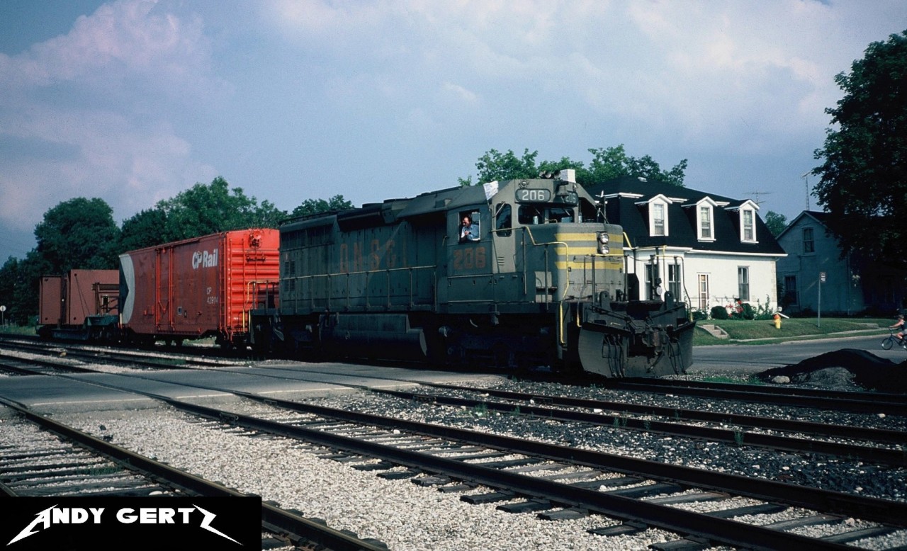 A CP westbound powered by Quebec, North Shore & Labrador Railway SD40 206 arrives in Galt in July 1984. This unit later became CP 5402 after being acquired by CP Rail. 

See the link for a William D. Miller photo of the same train on the same day. 

http://www.trainweb.org/galt-stn/cproster/locomotive/5400s/cp5402%20as%20qnsl206.htm
