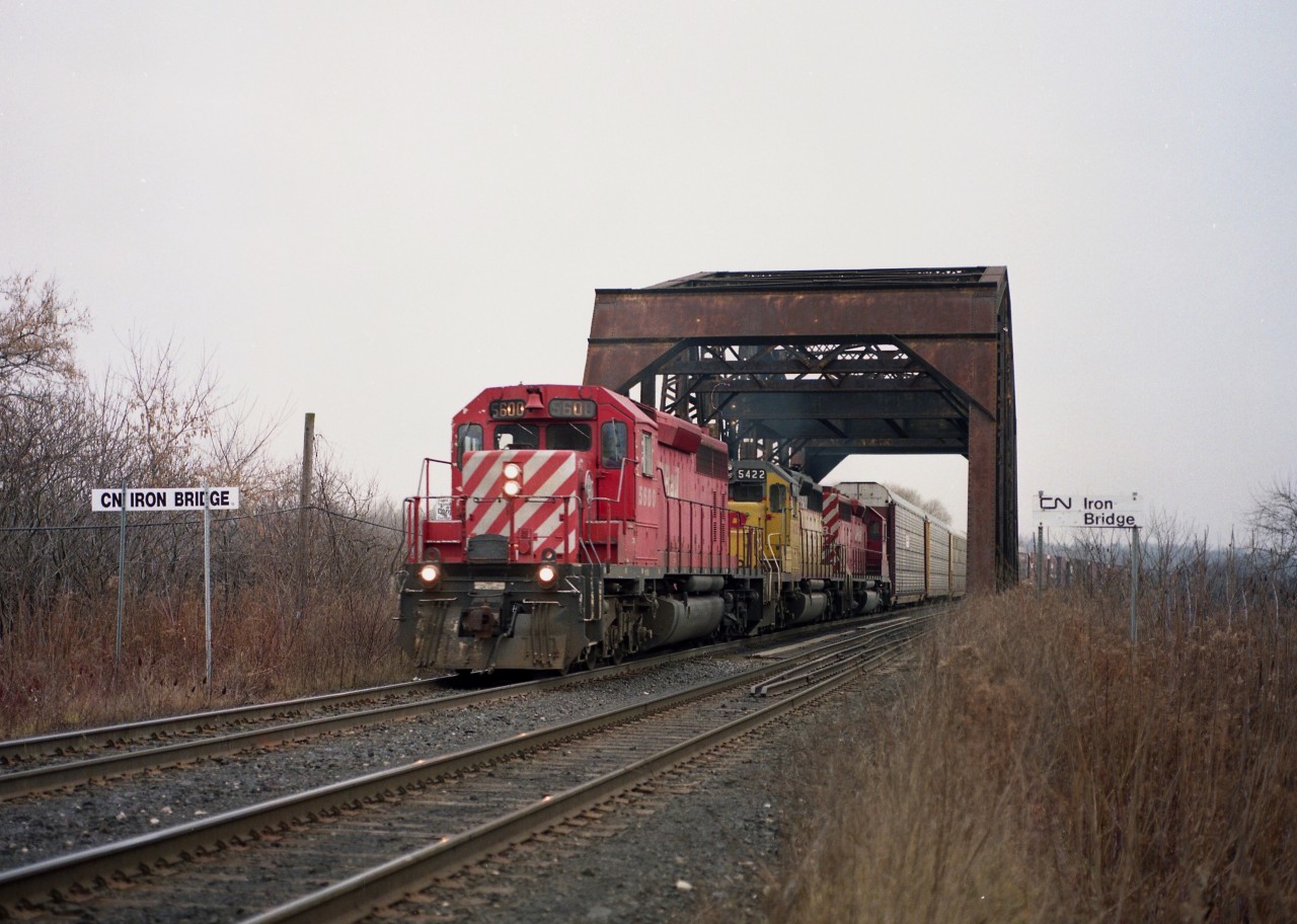 I guess you could say it was a typical non-descript day in December. A blank grey sky had me looking for a location to shoot trains that at least had some 'feeling' to it. So I wandered over to CN Iron Bridge (mile 7.7) to await #328 which I knew was on the way to Buffalo that morning.  It has today three CPs on the head end; CP 5600, 5422 and 5678.  The yellow loco was still in its previous coat as GATX 2000 from when it toiled as a leased unit on the D&H.