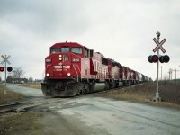 Curse the lousy weather!! I do realize it is just the imagination that says 'good train run on lousy days' but many times I really wonder.....On this rather grubby early spring day #422 is heading for the states and is seen here crossing Young St just outside of Smithville. Power is SOO 6058, 6604, CP 5813, 5617 and 6013. All units are gone from the CP/SOO roster now except for leader, an SD60M which now toils as CP 6258.