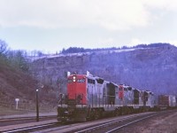 A gloomy day at Dundas, must have been cold with snow atop of the escarpment. Hanging out at Dundas station and 477 slogging up the grade with a trio of GP-9's. Great place to railfan. Kodak Instamatic memory from long ago.
