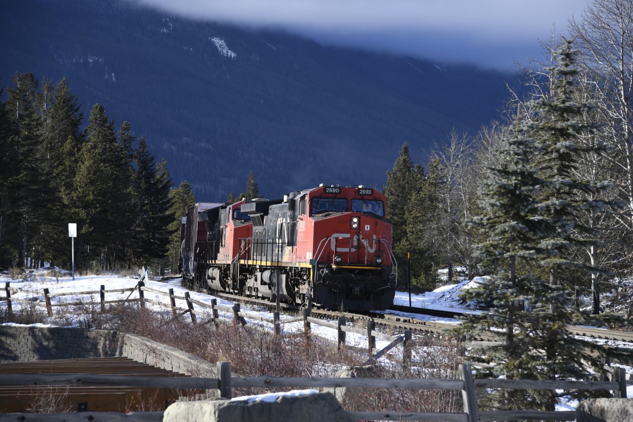 CN mixed freight  
CN 2690 & CN 3072 leading a mixed freight consist sit a few hundred feet east of CN Home Mile 0.55 Albreda Sub waiting for clearance into the yard at Jasper, AB. 
This photo was taken at the Hazel Avenue road crossing Mile 0.29 CN Albreda Sub. at the west end of Jasper yard where I spent numerous hours during each of my three days in town. There was a continuous string of east and westbound train traffic in and out of Jasper that could be easily viewed from this location. 
The Hazel street crossing is at the west end entrance to the CN yard and crew hostel and provided some nice views of the yard, the town, and the mountains while I waited for train movements. 
Two of the three days were sunny and blue, but all three were bitterly cold. Fortunately, it was only a stones throw to a variety of bake shops, coffee shops, and restaurants where a pastry and hot chocolate could be had! :-)