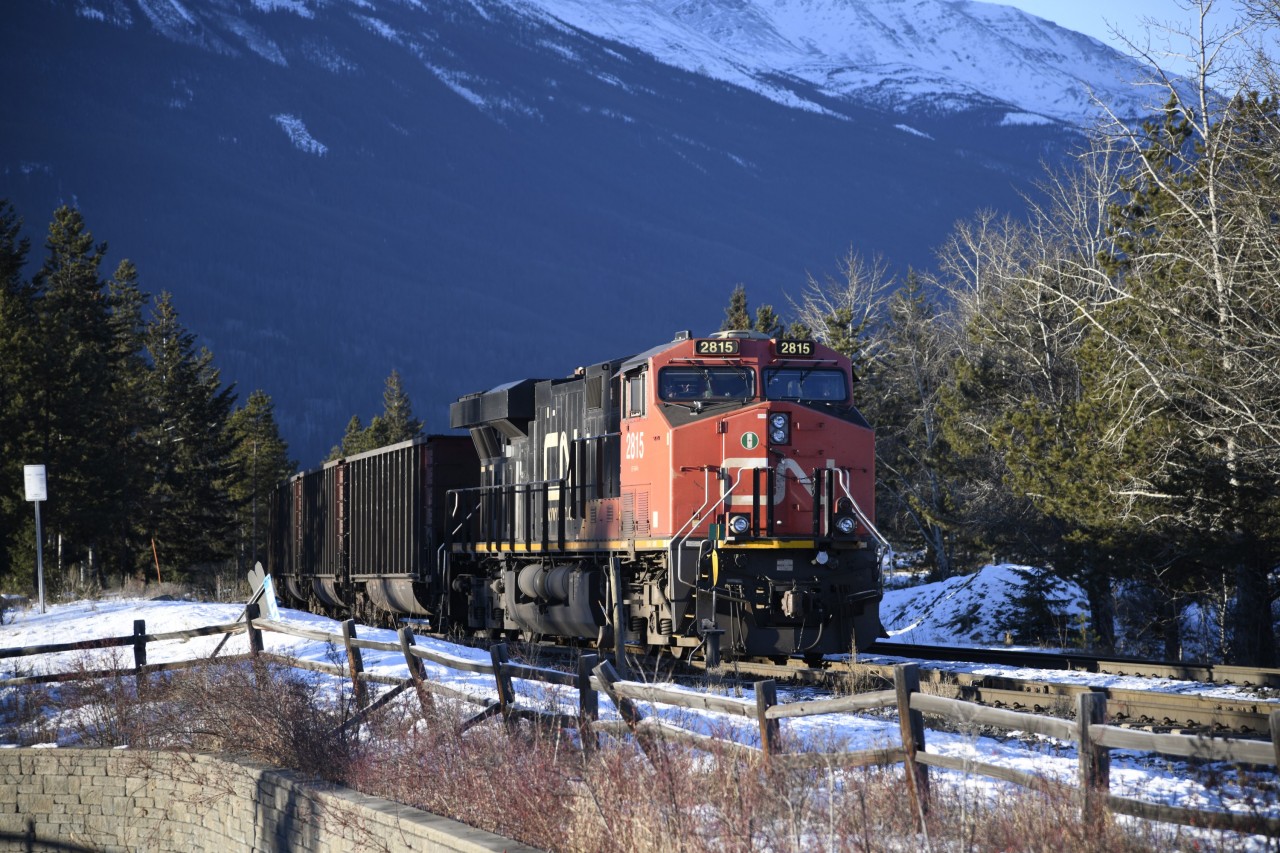 Waiting for clearance  
CN 2815 sits at the head end of an empty unit train of aluminum coal hoppers at Mile 0.29 on the Albreda Sub. just a few car lengths from the Hazel Avenue crossing in Jasper, AB. <br<
A new crew has climbed aboard and will begin the move into the yard as soon as they receive clearance to do so. 
This was my third day in Jasper on this trip and I was rewarded with clear skies and sunshine for the entire morning before I boarded VIA #2 The Canadian for the trip back to Toronto. :-)