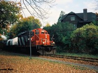 The last CN 15:30 Kitchener Job that I photographed going to Elmira in 1993, is viewed approaching Willow Street in Waterloo, Ontario with GP9RM 4111 leading two tank cars and caboose 79883 on the Waterloo Spur. 