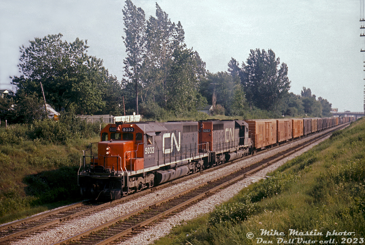 CN SD40's 5032 and 5062 roll eastbound on the Kingston Sub between Birchmount Road and Kennedy Road with train #392. A long block of Pacific Fruit Express reefers can be seen on the head end.

Mike Mastin photo, Dan Dell'Unto collection slide.