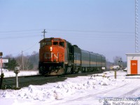 Borrowed CN GP40-2L(W) 9430 leads VIA train #73 westbound through Lynden on CN's Dundas Sub, with VIA F9B 6630 trailing ahead of four of the blue & yellow fleet. 
<br><br>
CN's GMD GP40-2L(W) group 9400-9449 were delivered in 1974 with faster 76mph gearing (60:17 gear ratio, instead of 62:17 gearing for regular max 65mph operation like the rest of the fleet). Some speculate this may have been for fast or express freight use. The units occasionally saw passenger service on VIA Rail, usually just one 9400 combined with a steam generator-equipped VIA unit that would provide steam heat to the passenger cars.
<br><br>
<i>Bill McArthur photo, Dan Dell'Unto collection slide.</i>