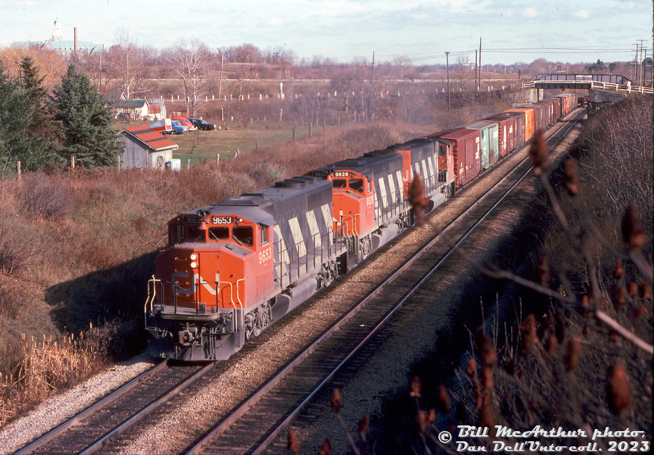 CN GP40-2W 9653, 9628, and another sister unit head up a westbound freight climbing the hill at Mile 1 of CN's Dundas Sub, as viewed from the footbridge. Bridges for Old Guelph Road and CP's Hamilton Sub can be seen in the distance.

Bill McArthur photo, Dan Dell'Unto collection slide (exact date unconfirmed, possibly November 11th 1978).