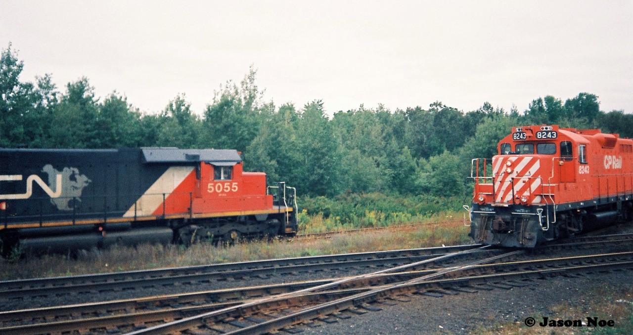 Back in September 1993 CN completed a large-scale bridge replacement west of Paris on the Dundas Subdivision. This resulted in CN rerouting trains not only on their Guelph Subdivision, but also detouring across Canadian Pacific’s Galt Subdivision for several days. In the west, the trains would begin their journey to the Galt Subdivision through the interchange track at Woodstock then onto the CP St. Thomas Subdivision for a short stretch before reaching the Galt mainline.

Here the CP Woodstock Afternoon Job with CP GP9u's 8243 and 8207 take priority as they head to the Cami facility meeting CN 392 with SD40’s 5055, 5029 and 5043 as they wait to proceed eastbound on the CP St. Thomas Subdivision on the CN-CP interchange track.

Note-I took the photo from the top of my dad's van trying to get the approaching CP train and stopped CN 392 as best I could in one frame as it was very tight.
