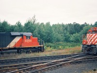 Back in September 1993 CN completed a large-scale bridge replacement west of Paris on the Dundas Subdivision. This resulted in CN rerouting trains not only on their Guelph Subdivision, but also detouring across Canadian Pacific’s Galt Subdivision for several days. In the west, the trains would begin their journey to the Galt Subdivision through the interchange track at Woodstock then onto the CP St. Thomas Subdivision for a short stretch before reaching the Galt mainline.
<br>
Here the CP Woodstock Afternoon Job with CP GP9u's 8243 and 8207 take priority as they head to the Cami facility meeting CN 392 with SD40’s 5055, 5029 and 5043 as they wait to proceed eastbound on the CP St. Thomas Subdivision on the CN-CP interchange track.
<br>
Note-I took the photo from the top of my dad's van trying to get the approaching CP train and stopped CN 392 as best I could in one frame as it was very tight. 