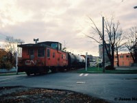 The last CN 15:30 Kitchener Job that I photographed going to Elmira in 1993, is viewed crossing Willow Street with GP9RM 4111 leading two tank cars and caboose 79883 heading into downtown Waterloo, Ontario on the Waterloo Spur.