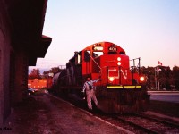 Just as the late September sun has dipped below the horizon, the CN 15:30 Kitchener Job slowly passes the former Grand Trunk station as it approaches Regina Street in downtown Waterloo, Ontario. The job is powered by GP9RM 4108 and is taking one car to Elmira along with caboose 79883. 
