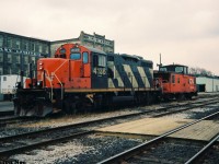 During a weekday afternoon, CN GP9RM 4136 and caboose 79883 are viewed parked awaiting their next job in front of the Kitchener, Ontario station.