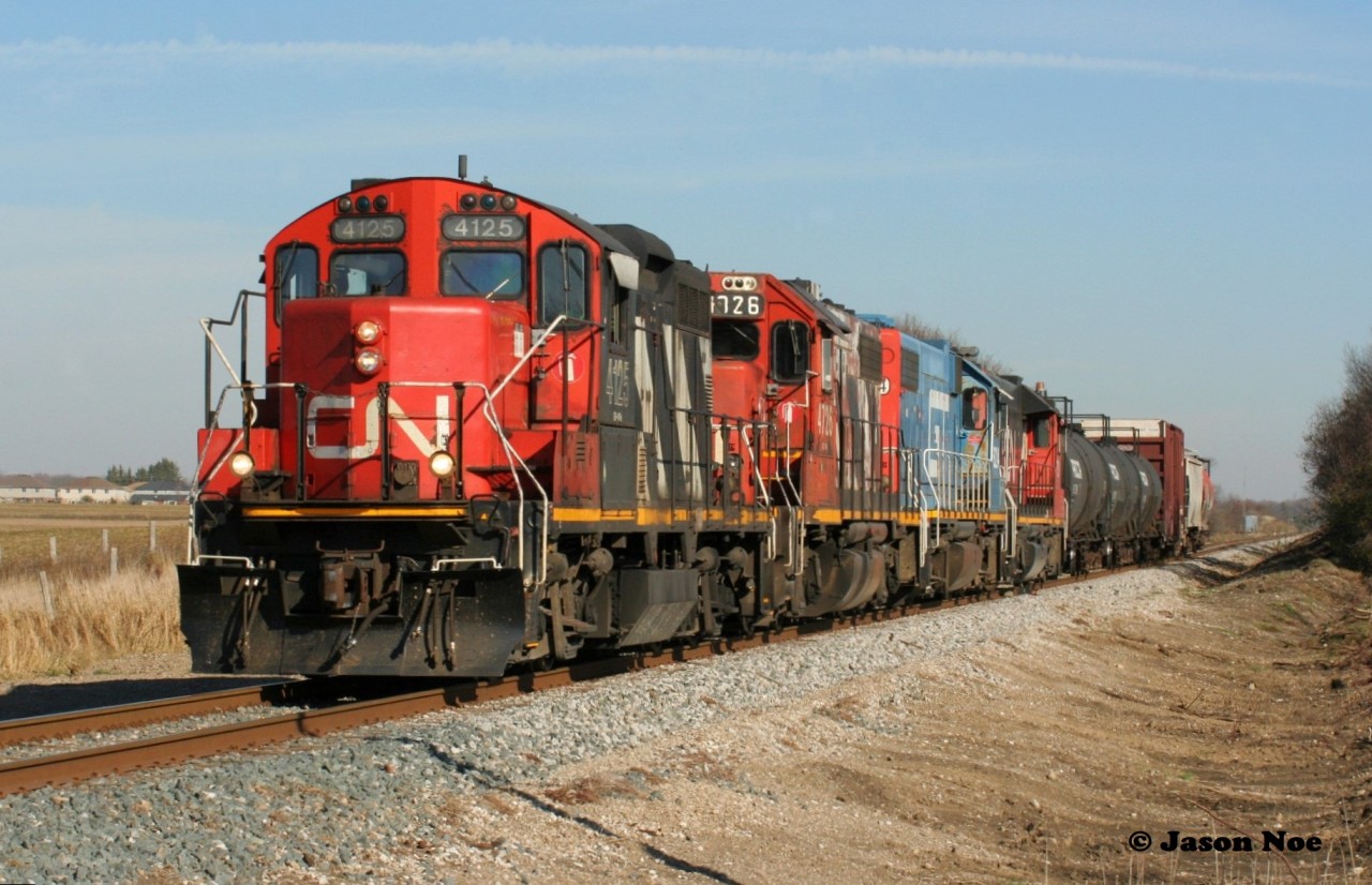 CN L568 is just west of Baden, Ontario on the Guelph Subdivision approaching Nafziger Road with a short train. The consist includes; 4125, 4726, GTW 5849 and 7515.