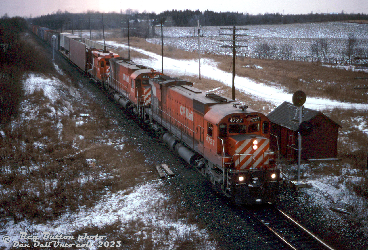 On a gloomy winter's day in December, CP train #904 rolls past the sectonman's shanty at Puslinch on the Galt Sub, lead by M636 4727, M630 4557, and GP30 5000 (one of CP's two GP30 units, and the only two that were Canadian-built by GMD in London). Some open autorack and piggyback traffic follows on the head end.

Reg Button photo, Dan Dell'Unto collection slide.