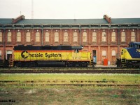 CSX train R320 with CSX GP38 2012 and CSX SD40-2 8060 with C&O caboose #904121 are paused by the iconic former CASO station in St. Thomas during a humid August 1993 day. The train is seen meeting CSX R321 with CSX C40-8W’s 7737 and 7694 with C&O caboose 904125, much to the delight of those attending the weekend St. Thomas railway day's festivities.