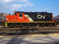 CN GMD GP9RM 7080 rests in the yard at Brantford.  7080 was built in 1957 as CN 4121, renumbered CN 4377 in 1984, and finally rebuilt to 7080 in 1993.<br><br><i>Roger Chapman Photo, Bruce Acheson Collection Slide.</i>