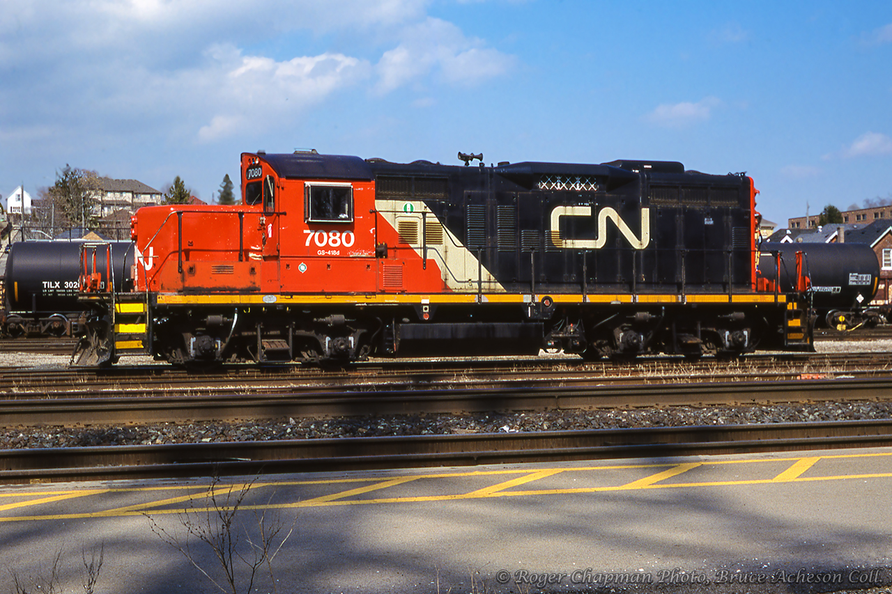 CN GMD GP9RM 7080 rests in the yard at Brantford.  7080 was built in 1957 as CN 4121, renumbered CN 4377 in 1984, and finally rebuilt to 7080 in 1993.Roger Chapman Photo, Bruce Acheson Collection Slide.