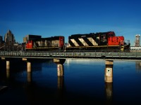 The crossing gates are starting to go up at left as CN 500 leaves the Port of Montreal light power after bringing in baretables.