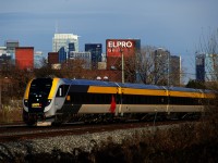 Finally having a VIA reporting mark and no longer using the SIIX one, cab car VIA 2302 leads VIA 35 past the Montreal skyline.