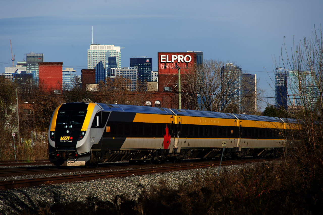 Finally having a VIA reporting mark and no longer using the SIIX one, cab car VIA 2302 leads VIA 35 past the Montreal skyline.