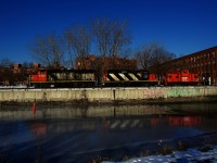 After dropping off cars at Ardent Mills, CN 500 is heading west along the frozen Lachine Canal. Soon it will use a runaround track to move the caboose to the west end of the power, before heading to Track 29 to pick up grain cars.