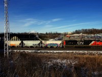 CN 8880 leads CN 368 through Pointe-Claire. Another SD70M-2 (CN 8888) is operating mid-train.