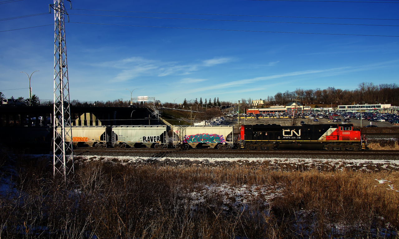 CN 8880 leads CN 368 through Pointe-Claire. Another SD70M-2 (CN 8888) is operating mid-train.