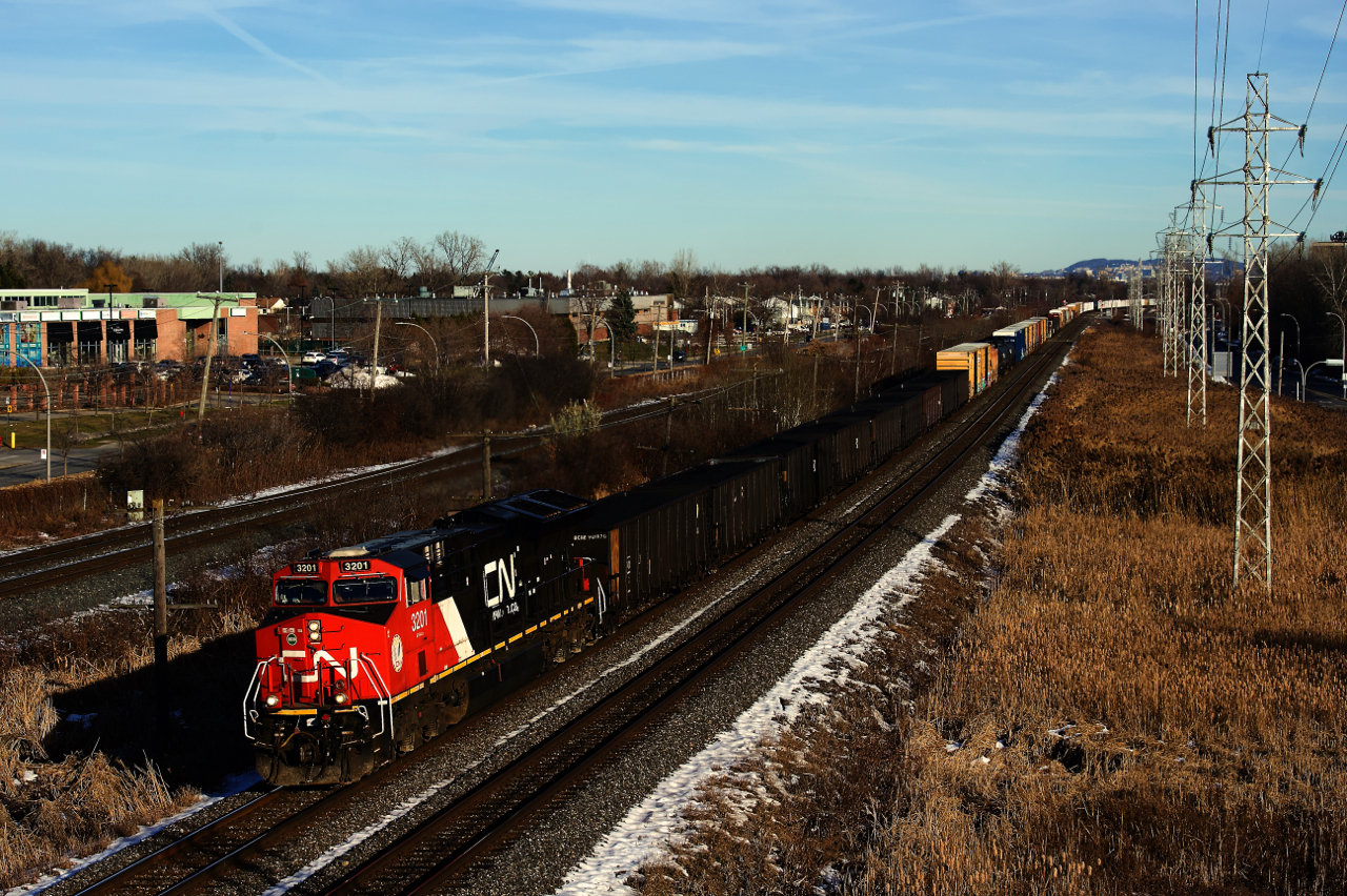 Very little coal moves by rail through Montreal, generally the small amount that does is eastbound or northbound and headed towards Bécancour. So I was quite surprised to see 9 loaded coal hoppers on the head end of westbound CN 369. Here it heads west with CN 3201 up front and CN 3333 mid-train.