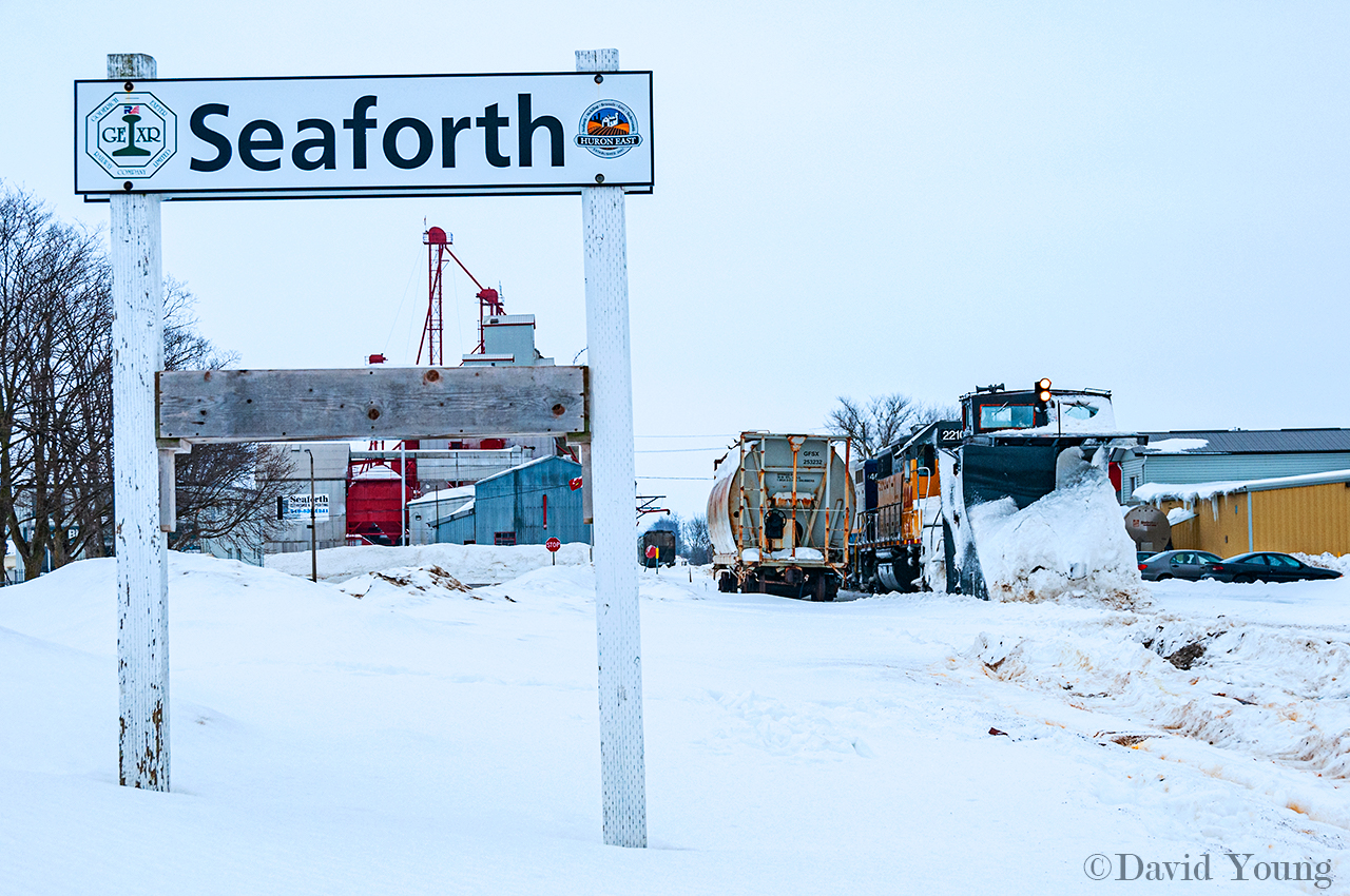 I've been hearing word that the old plow in Stratford is in rough shape, and unlikely to be used anytime soon (if not again). However it's not likely they'll be needing it the weather keeps going the way it is (currently +4C and raining mid way thru December). I offer up this goodie of better times. The crew of plow extra X518 has stopped in Seaforth for a coffee and bit of "housecleaning". A large amount of heavy, wet snow has accumulated in the doorways and walkways of the locomotives, this stop will provide some relief to additional snow build up during their assault on the remainder of the Goderich Sub. Power for the run was LLPX 2210-RLK 4001-HLCX 6091.