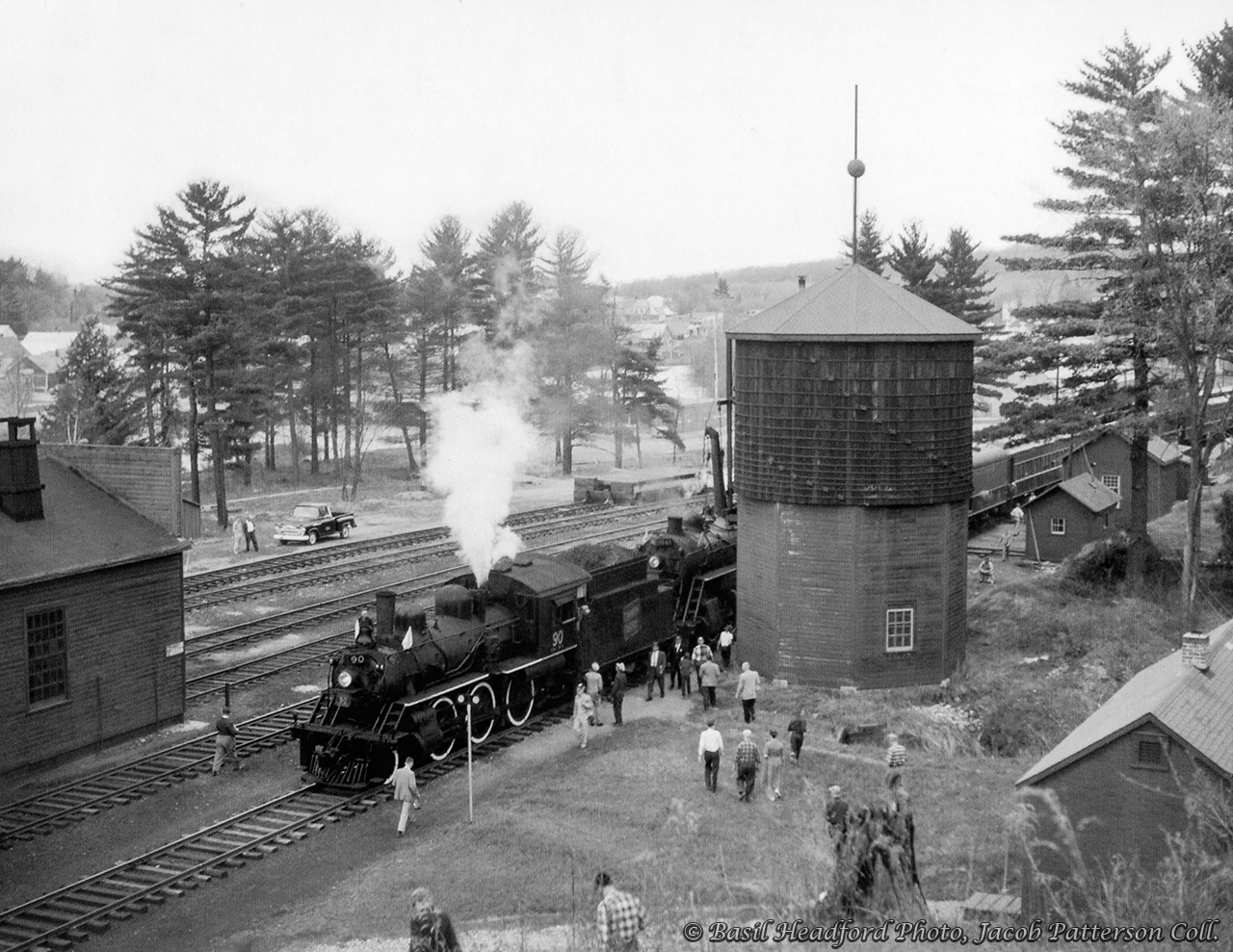 The joint excursion of the Upper Canada Railway Society and Canadian Railroad Historical Association behind E-10-a 2-6-0 90 and N-4-a 2-8-0 2649 is seen pausing briefly at Bancroft before continuing north to wye at York River.  The train had stopped to allow local children to board the train for a ride up to the wye and back, after which the locomotives would take on coal and water. Departing Belleville amid the light rain that morning at 0645h - with a crew from the National Film Board setup in the baggage car - the excursion ran along the Campbellford Subdivision to Anson Junction, taking the east leg of the wye onto the Maynooth Subdivision. Seen here, the train would pause briefly at Bancroft before proceeding three miles north to York River where the train could be wyed for the return trip. Arriving back at Anson Junction, the excursion would continue south into Trenton, turning on the wye before returning north to Trenton Junction to rejoin the Oshawa Sub mainline for the short twelve mile run back to Belleville. The special reached a top speed of 55mph on the high iron, running barely 30 minutes ahead of Toronto - Montreal train 6, due into Belleville at 1815h.Notes of the trip per John Freyseng's extensive article in the June 1959 UCRS newsletter. Neither of these locomotives would last another year, with 90 meeting the torch in February 1960, and 2649 that March.Basil Headford Photo, Jacob Patterson Collection.