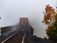Into the murk....will it ever be seen again? A 100 series CN monster crosses the Seguin River trestle on a very foggy morning.