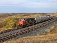 G 84451 25 an empty G3 grain shuttle for Booth, Saskatchewan cruises through Keppel on a windy September morning.  Keppel is a neat location just east of Biggar, where the CPKC Wilkie Sub runs along side the CN Watrous Sub through some rolling hills that break the monotony of the Saskatchewan Prairie. 