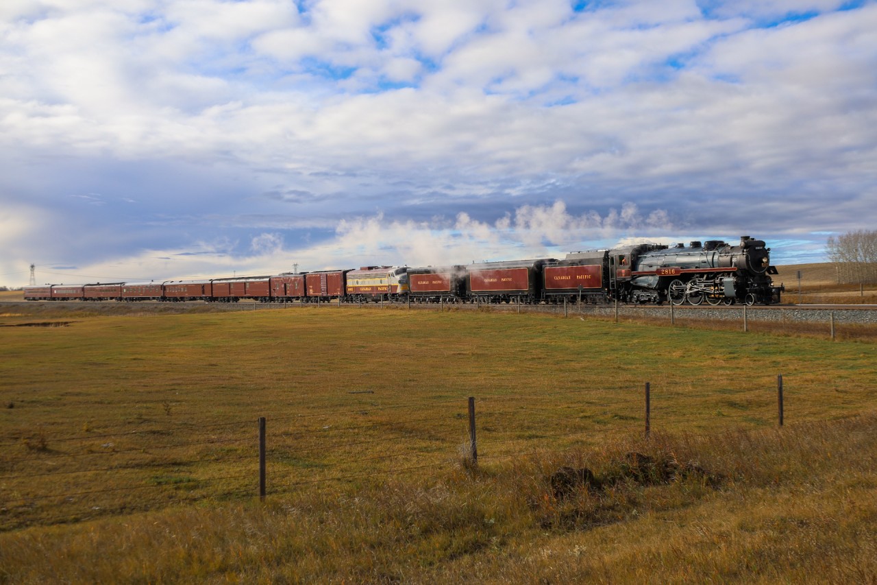 After a rainy morning in Calgary, the sun breaks through the clouds as CP 2816 North highballs through Crossfield.